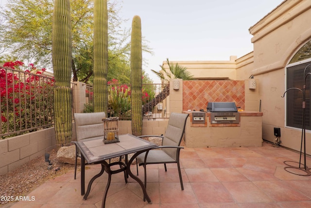 view of patio / terrace with area for grilling and a fenced backyard