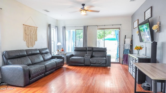 living room featuring ceiling fan and light hardwood / wood-style floors