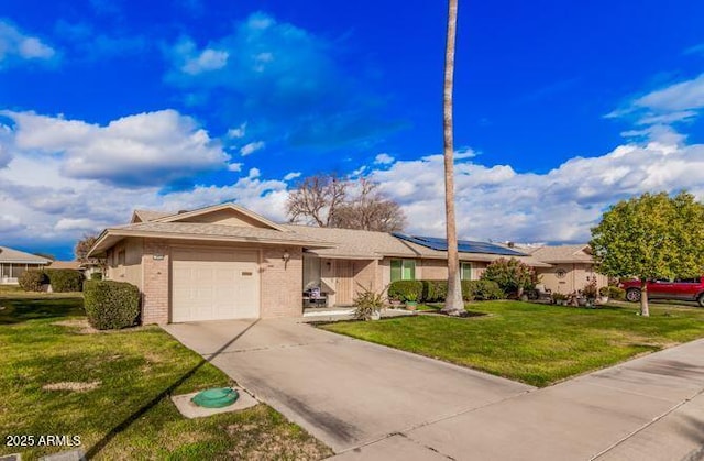 ranch-style home featuring a garage and a front yard