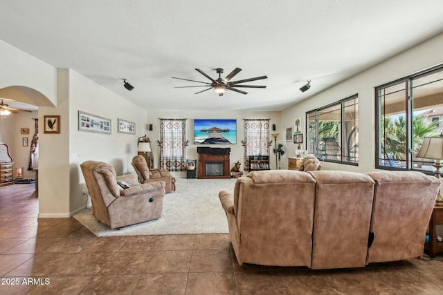 living room featuring ceiling fan and tile patterned flooring