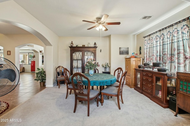 dining space featuring light tile patterned flooring and ceiling fan