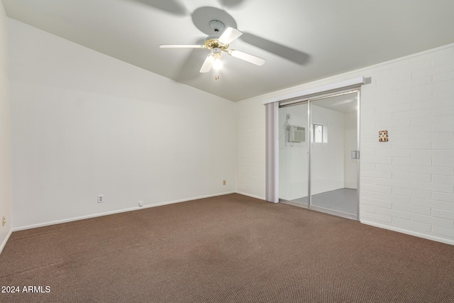 unfurnished bedroom featuring an AC wall unit, carpet flooring, a closet, and ceiling fan