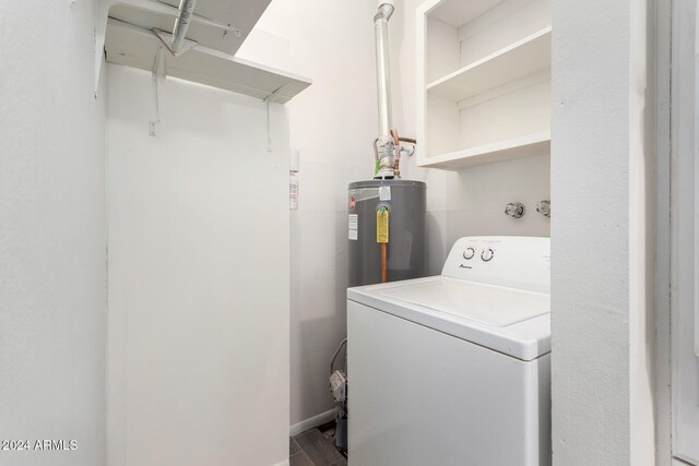 washroom with water heater and washer / clothes dryer