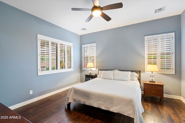 bedroom with baseboards, visible vents, wood-type flooring, and ceiling fan