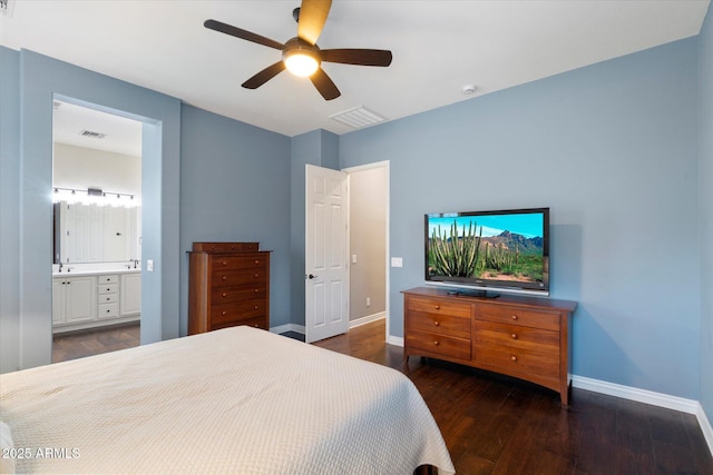 bedroom featuring a ceiling fan, wood finished floors, visible vents, baseboards, and ensuite bath