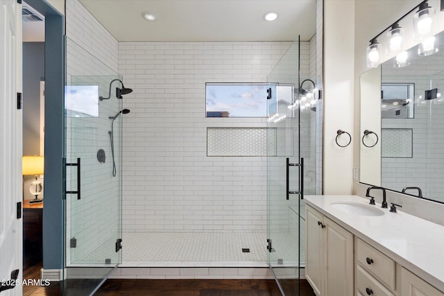 bathroom featuring vanity, a shower stall, and recessed lighting