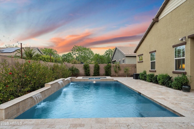 view of swimming pool with a patio, a pool with connected hot tub, and a fenced backyard