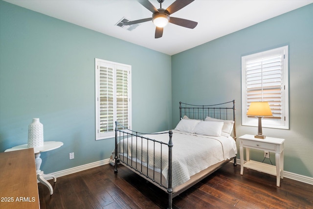 bedroom featuring ceiling fan, visible vents, baseboards, and hardwood / wood-style floors