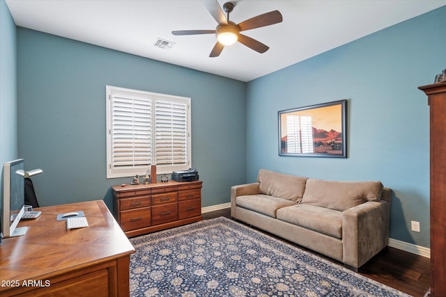 office space featuring visible vents, baseboards, wood finished floors, and a ceiling fan