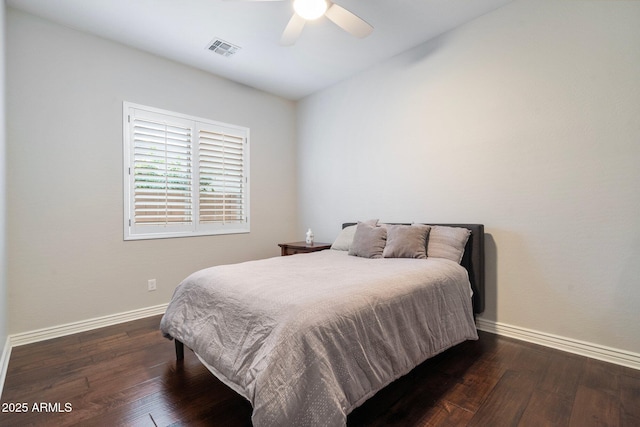 bedroom featuring visible vents, baseboards, and wood-type flooring