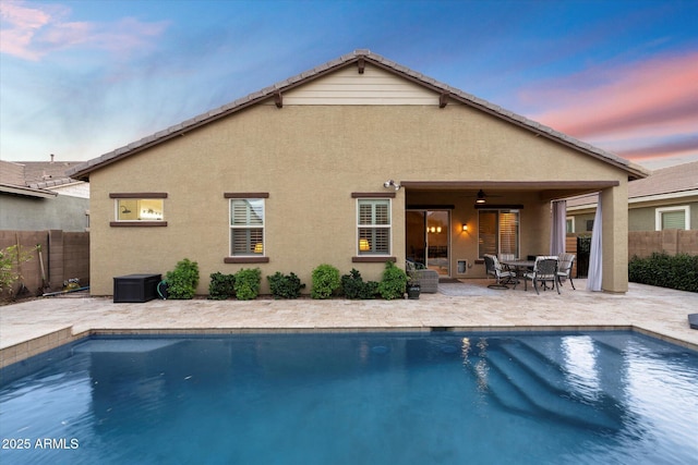 view of swimming pool featuring a fenced in pool, a patio, ceiling fan, and fence