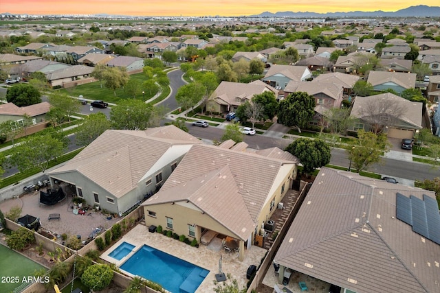 aerial view at dusk featuring a residential view