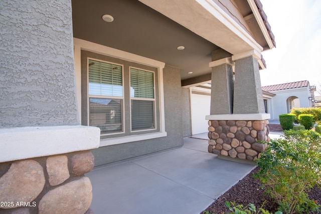 entrance to property featuring stucco siding