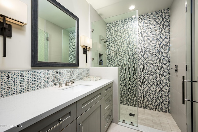 bathroom featuring walk in shower, tile patterned floors, and vanity