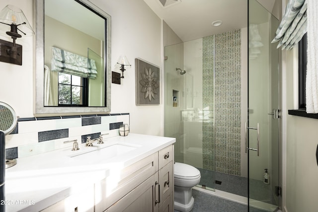 bathroom featuring vanity, toilet, an enclosed shower, and decorative backsplash