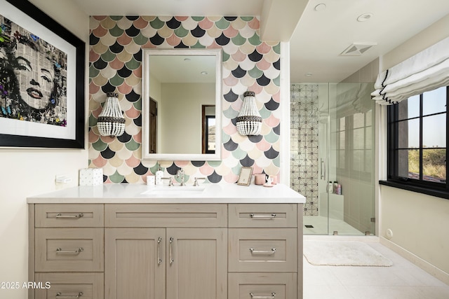 bathroom featuring vanity and a shower with shower door