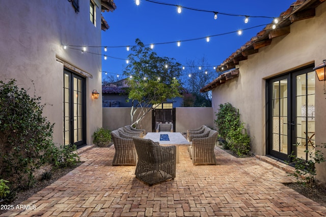 view of patio with french doors and an outdoor fire pit