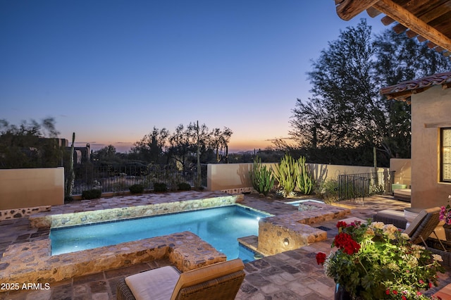 view of pool at dusk