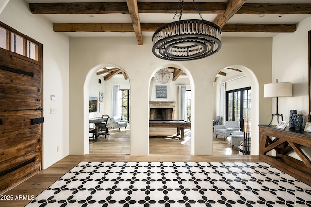 entrance foyer with hardwood / wood-style flooring and beamed ceiling