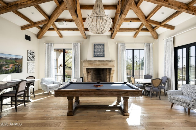 recreation room with french doors, pool table, light hardwood / wood-style flooring, a notable chandelier, and beamed ceiling