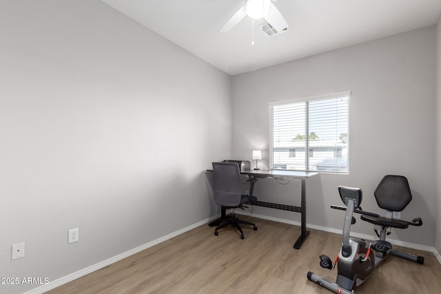 home office with ceiling fan and light hardwood / wood-style floors