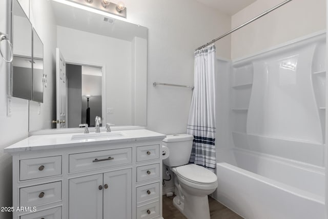 full bathroom with vanity, shower / bath combination with curtain, and toilet