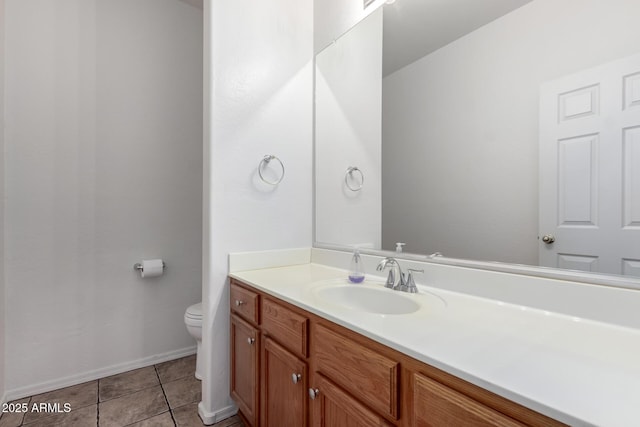 bathroom featuring tile patterned flooring, vanity, and toilet