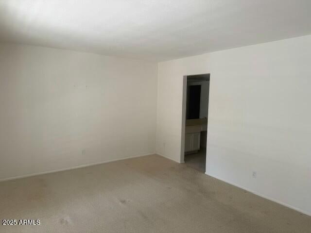 unfurnished room with light colored carpet