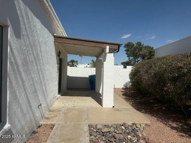 view of home's exterior featuring fence and stucco siding