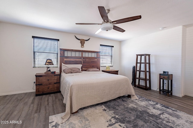 bedroom with wood finished floors, baseboards, and ceiling fan