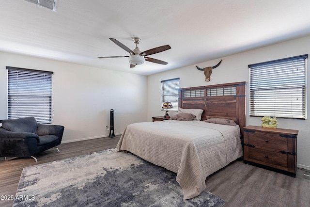 bedroom featuring wood finished floors, baseboards, and ceiling fan