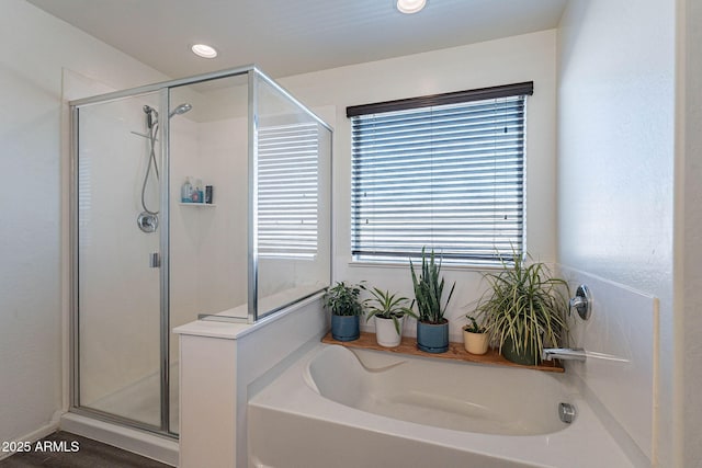 full bathroom featuring a stall shower, a garden tub, and recessed lighting