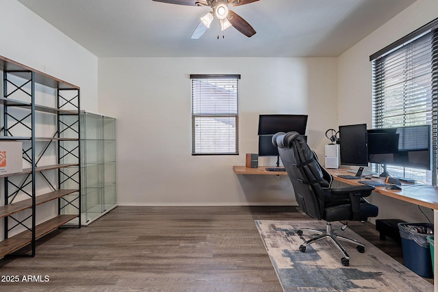 office space with healthy amount of natural light, wood finished floors, a ceiling fan, and baseboards