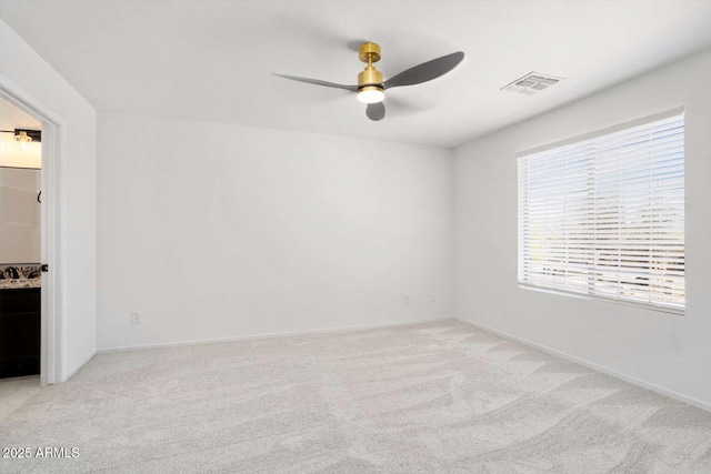 23772 W Grove St, Buckeye, AZ 85326 - spare room with ceiling fan, light carpet, and baseboards