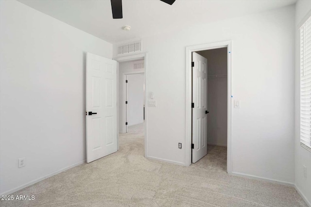 23772 W Grove St, Buckeye, AZ 85326 - unfurnished bedroom with carpet flooring, a walk in closet, baseboards, and a ceiling fan
