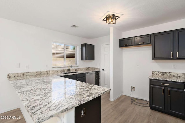 23772 W Grove St, Buckeye, AZ 85326 - kitchen with a sink, a peninsula, dishwasher, and light wood-style floors