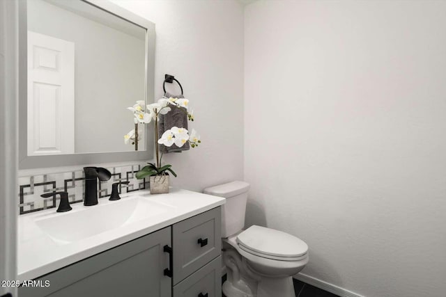 23772 W Grove St, Buckeye, AZ 85326 - bathroom with vanity, toilet, tasteful backsplash, and baseboards