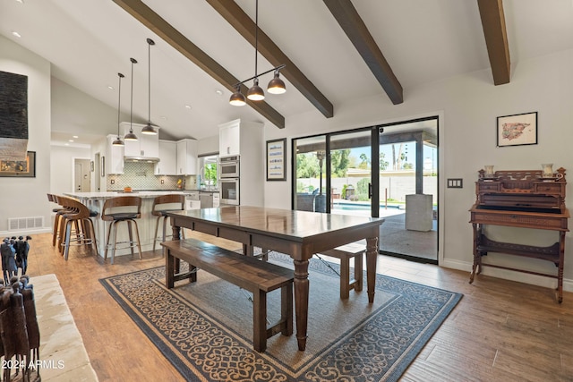 dining space featuring light hardwood / wood-style flooring and high vaulted ceiling