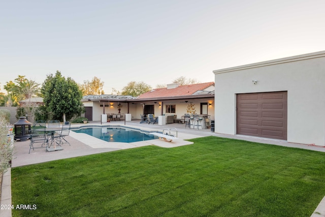 view of pool featuring a patio and a lawn