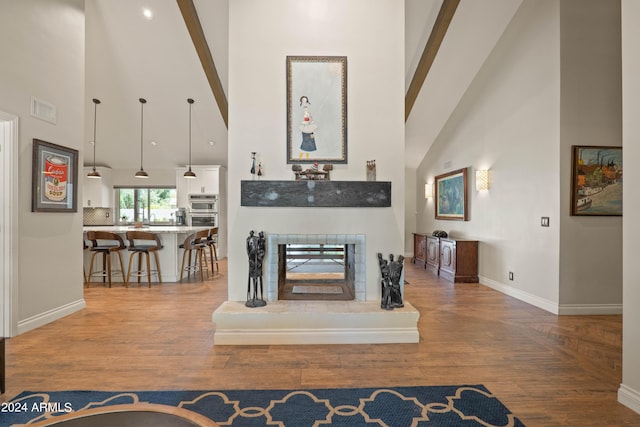 living room with hardwood / wood-style flooring and a high ceiling