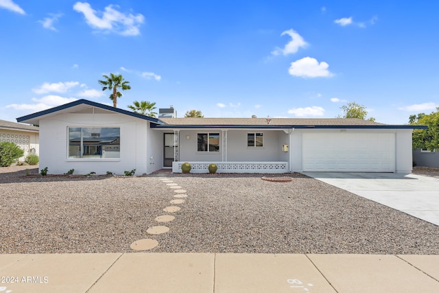 single story home featuring covered porch and a garage