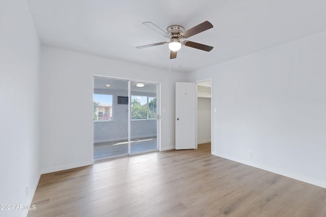 unfurnished room with light wood-type flooring and ceiling fan