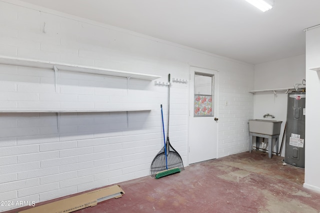 misc room with water heater, sink, and concrete floors