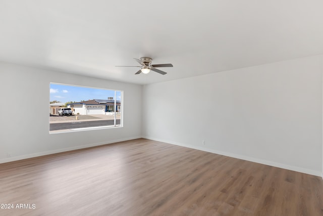 spare room with wood-type flooring and ceiling fan