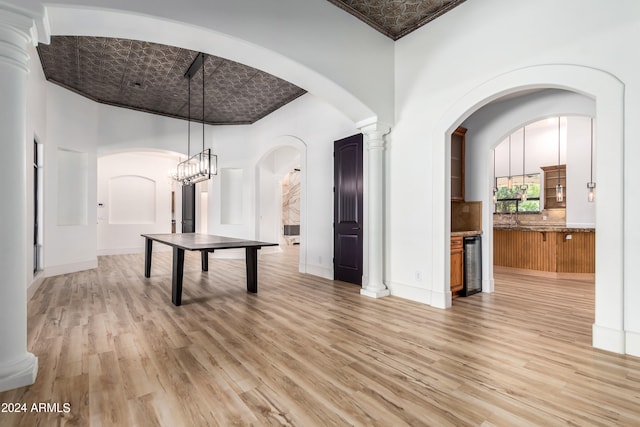 interior space with a high ceiling, light hardwood / wood-style flooring, and a chandelier