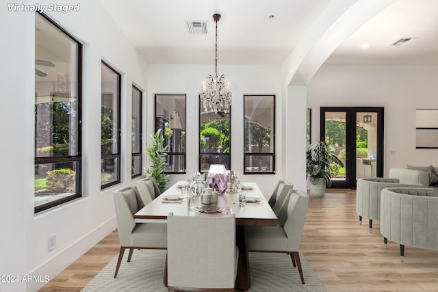 dining room featuring light hardwood / wood-style flooring and an inviting chandelier