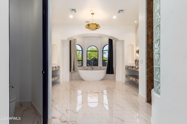 bathroom featuring a tub to relax in