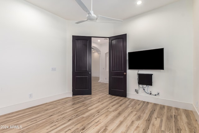 unfurnished bedroom with ceiling fan and light hardwood / wood-style flooring