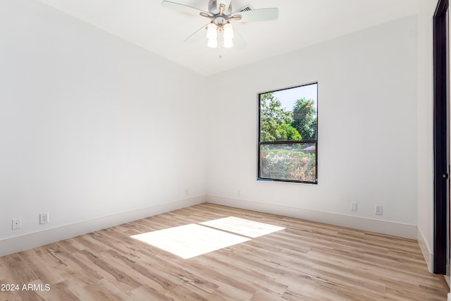 spare room featuring light hardwood / wood-style flooring and ceiling fan