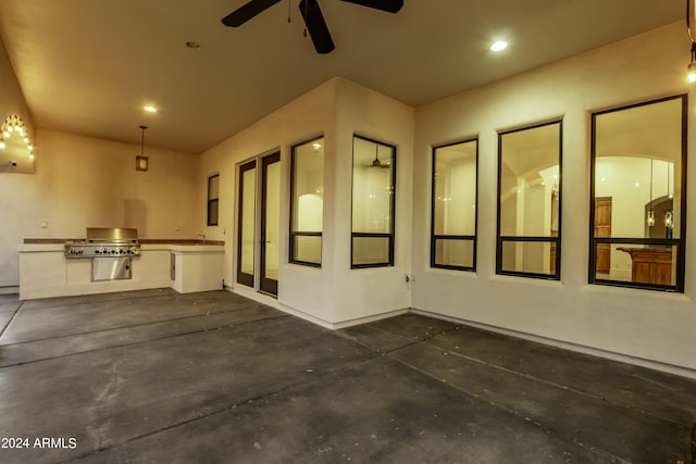 view of patio with sink, a grill, and ceiling fan